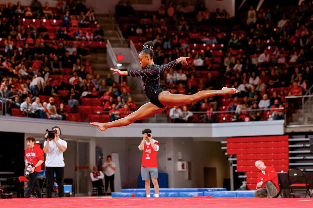 Sophomore Ashley Knight leaps into the air during her floor routine during the match against California in Reynolds Coliseum on Sunday, Feb. 2, 2025. Knight scored a career best of 9.925. NC State lost to California 197.175-196.550.