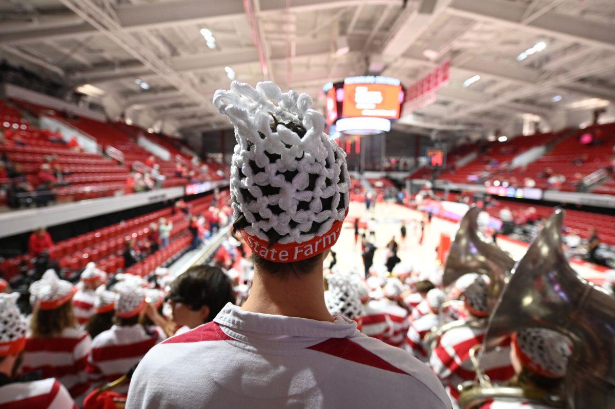 Members of the NC State marching band, the Power Sound of the South, donn basketball net hats for the College Gameday matchup between the Wolfpack and the number one ranked Notre Dame Fighting Irish in Reynolds Coliseum on Sunday, Feb. 23, 2025. The Wolfpack beat the Fighting Irish 104-95 in double overtime.
