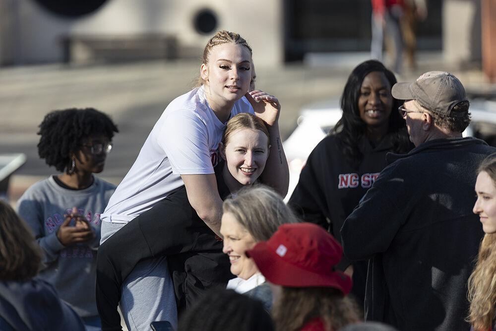 Sophomore guard Laci Steele piggybacks on sophomore forward Maddie Cox at the Memorial Belltower on Sunday, Feb. 23, 2025. After their victory over top-ranked Notre Dame, the women's basketball team celebrated with fans at the Belltower.