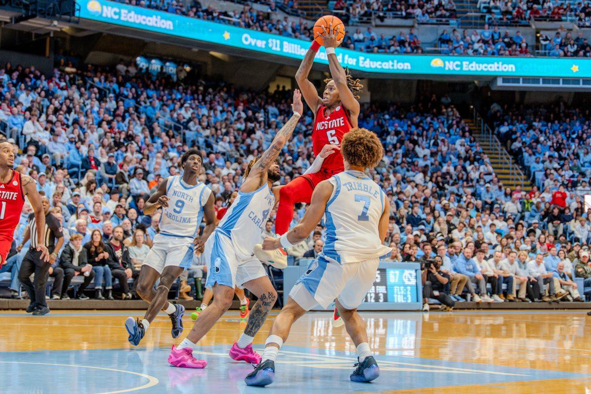 Freshman guard Trey Parker attempts a shot during the game against the University of North Carolina Chapel Hill in the Dean E. Smith Center on Wednesday, Feb. 19, 2025. Parker scored four points and made one rebound. NC State lost the game 97-73.