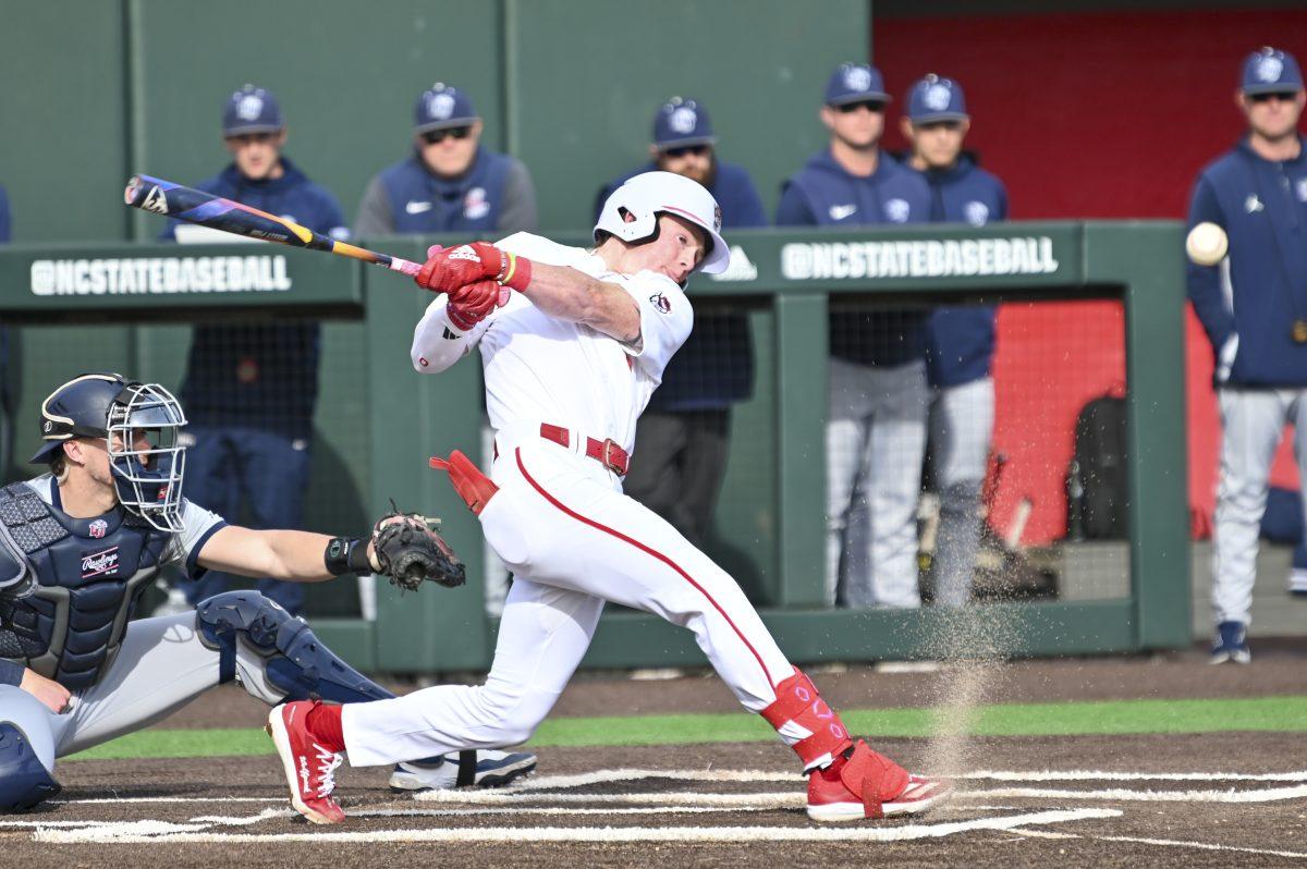 Sophomore infielder Luke Nixon hits the ball during the baseball game against Liberty on Doak Field at Dail Park on Tuesday, Feb. 18, 2025. Nixon led the Wolfpack in runs with two total. NC State lost to Liberty 8-9.