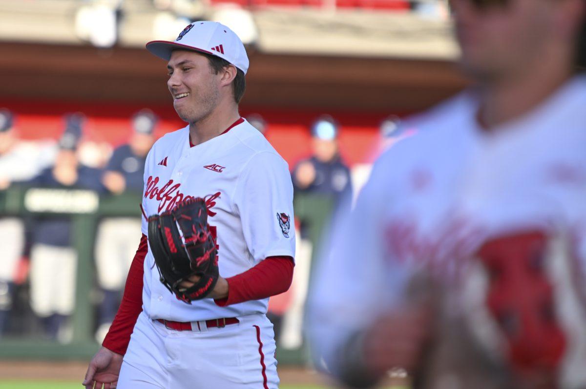 Freshman pitcher Anderson Nance smirks after getting a player out without moving during the baseball game against Liberty on Doak Field at Dail Park on Tuesday, Feb. 18, 2025. The batter hit the ball into Nance's hand. Nance pitched for 3.0 innings and allowed only one hit. NC State lost to Liberty 8-9.