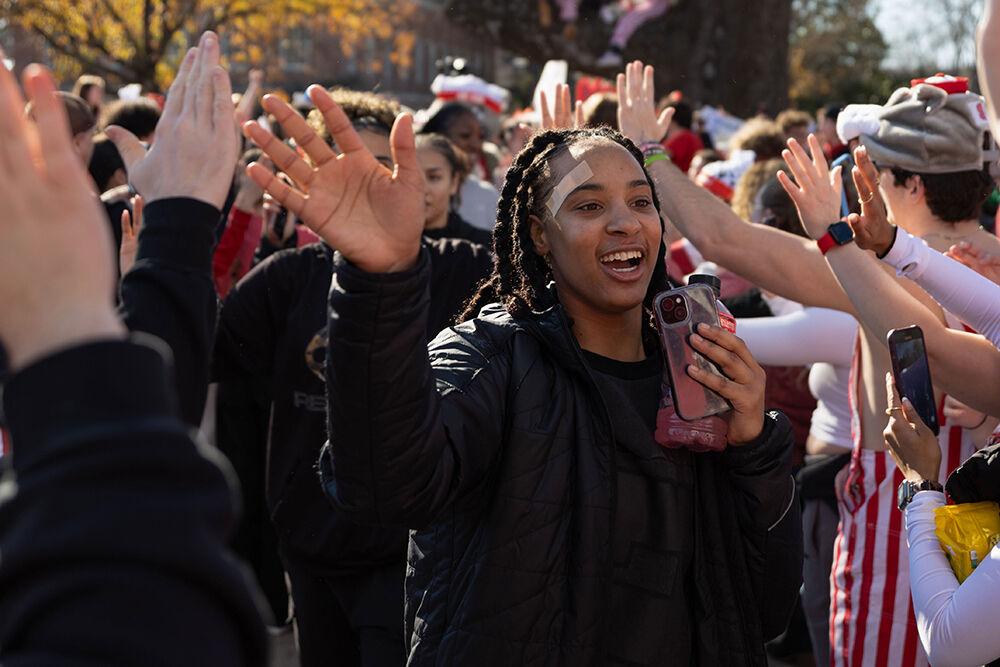 Senior guard Aziaha James smiles as she high-fives fans at the Memorial Belltower on Sunday, Feb. 23, 2025. Fans celebrated the Wolfpack's 104-95 victory over top-ranked Notre Dame.