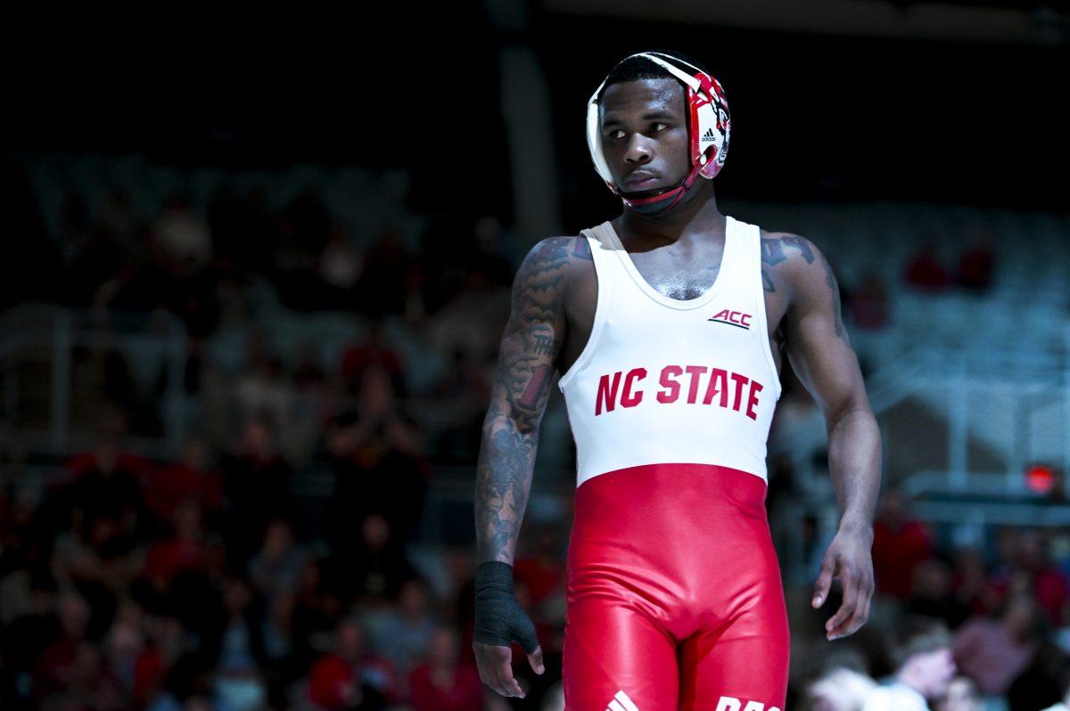 Redshirt freshman Vince Robinson walks onto the mat during the wrestling match against UNC-Chapel Hill in Carmichael Arena on Friday, Jan. 31, 2025. Robinson won the 125 bout 10-4, securing the win for the Wolfpack. NC State beat Chapel Hill 19-16.