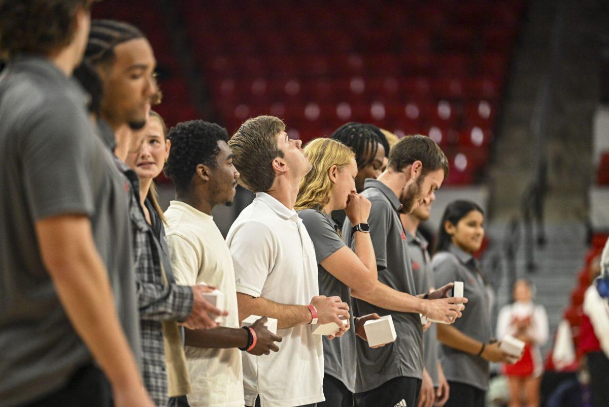 NC State students look at their rings during the halftime of NC State vs Anderson in Reynolds Coliseum on Tuesday, Oct. 29, 2024.