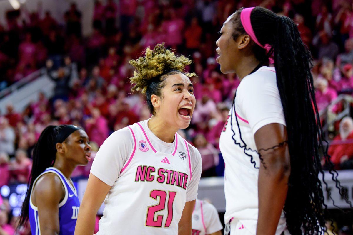 Senior guard Madison Hayes yells at freshman center Lorena Awou after Awou blocked a shot during the Play4Kay game against Duke in Reynolds Coliseum on Monday, Feb. 3, 2025. The Wolfpack beat the Blue Devils 89-83.