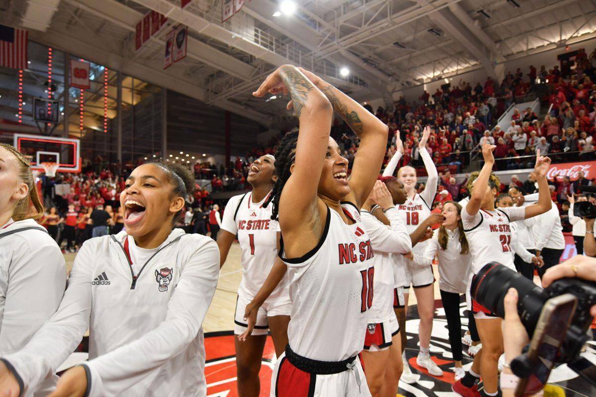 Senior guard Aziaha James and the NC State women's basketball team celebrate after the game against the Notre Dame Fighting Irish in Reynolds Coliseum on Sunday, Feb. 23, 2025. James scored 20 points and recorded five rebounds and two assists. The Wolfpack beat the number one ranked Fighting Irish 104-95 in double overtime.
