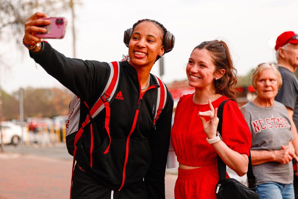 Senior guard Aziaha James takes a selfie with a few fans during the teams welcome back to Reynolds Coliseum on Saturday, March 29. James played in all 35 games during her senior season averaging 17.9 points per game.
