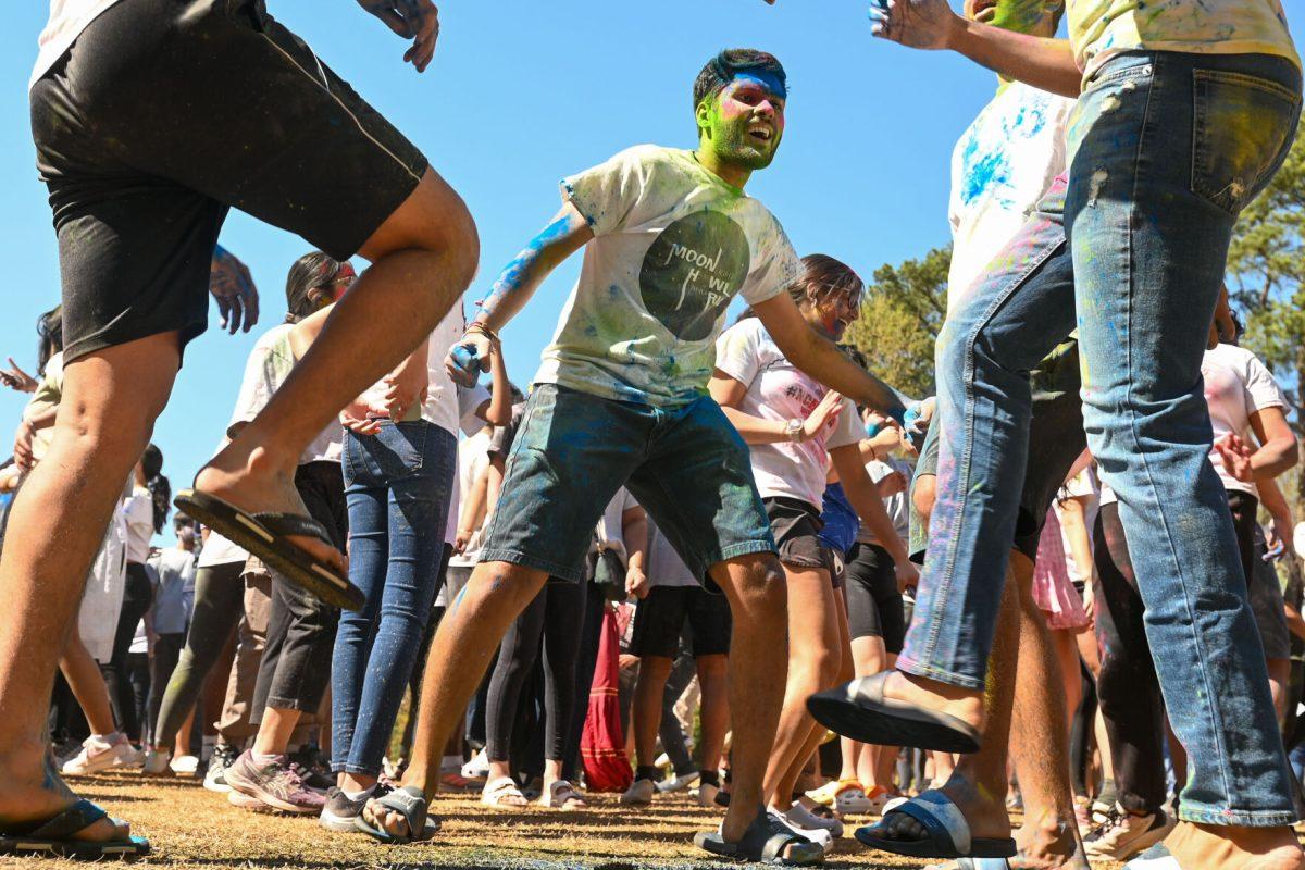Jash Gopani, a graduate student studying computer science, dances with his friends after being colored during Holi at Stafford Commons on Saturday, March 22, 2025. Holi was thrown by EKTAA, NC State's South Asian Student Association.