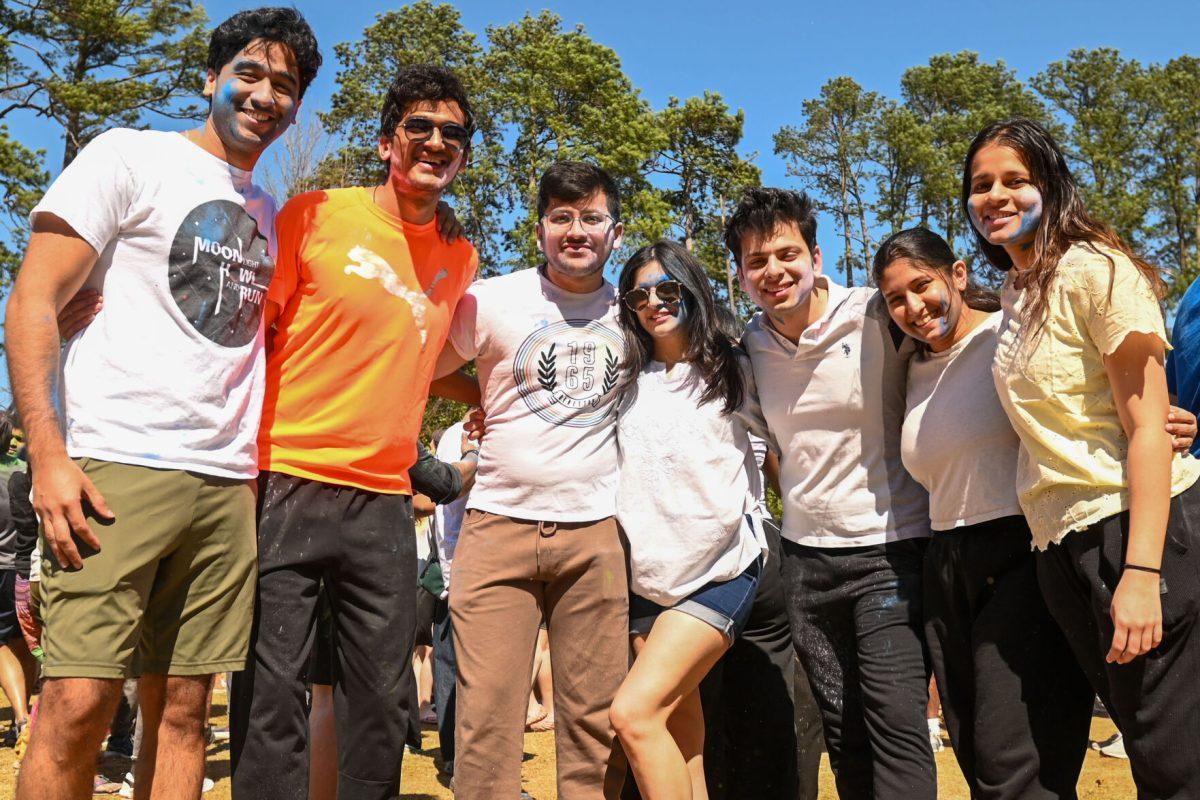 A group of friends pose together during Holi at Stafford Commons on Saturday, March 22, 2025. Holi is known as the Festival of Colors, and celebrates spring by throwing colored powder.