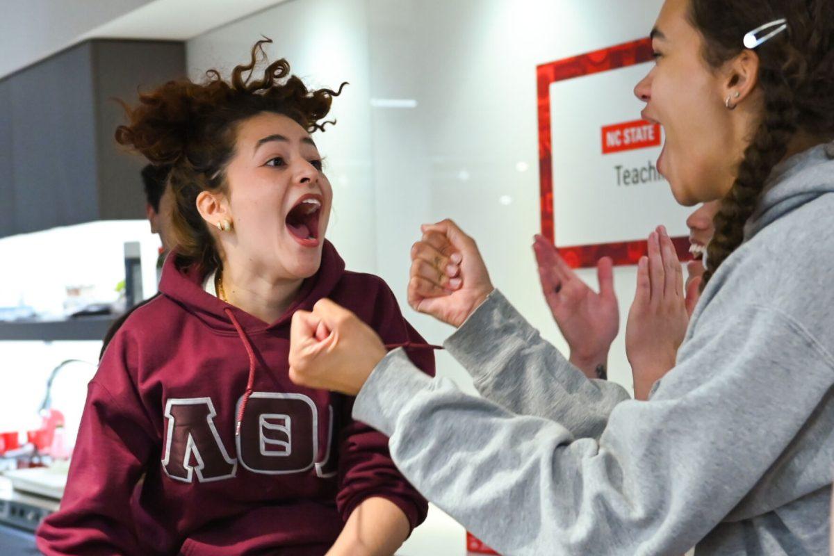 Team two celebrates by jumping up and down after winning the challenge during the MGC Chopped: Cooking Competiton at Carmichael Gym on Wednesday, March 26, 2025. The winning team prepared a dish that won by one point over their opposers.