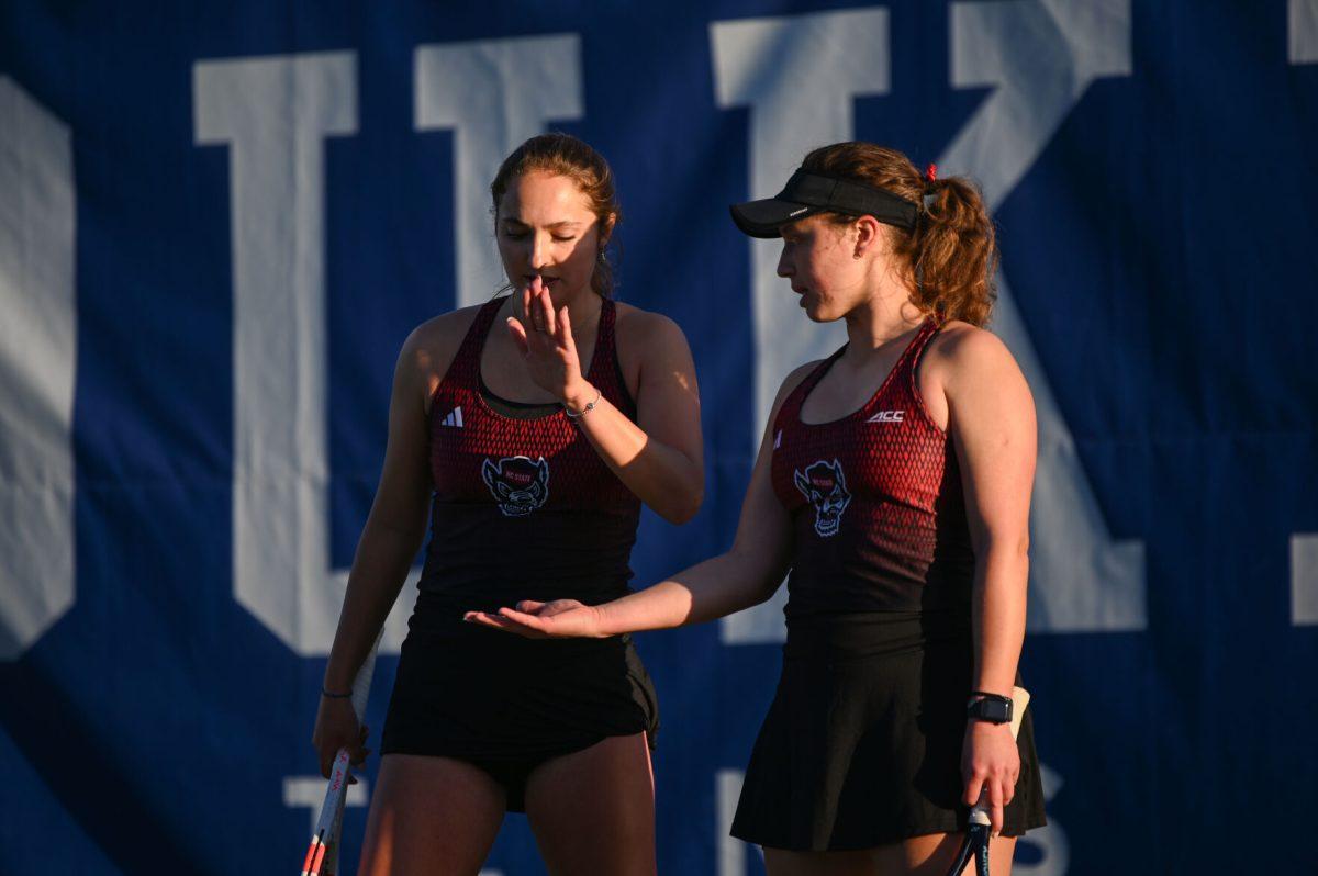 Sophomore Jasmine Conway and junior Anna Zyryanova high-five during their doubles match against Duke at Ambler Tennis Stadium on Friday, March 21, 2025. The pair lost their doubles match 7-5. NC State fell to Duke 3-4.