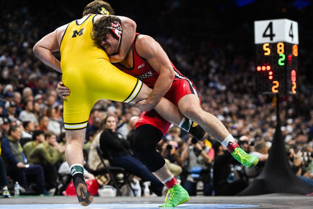 Redshirt junior Isaac Trumble tackles his opponent during the NCAA Wrestling Championship Tournament in the Wells Fargo Center on Thursday, March 20, 2025. Trumble finished fourth for the heavyweight class. NC State placed eighth overall with 46.5 points.