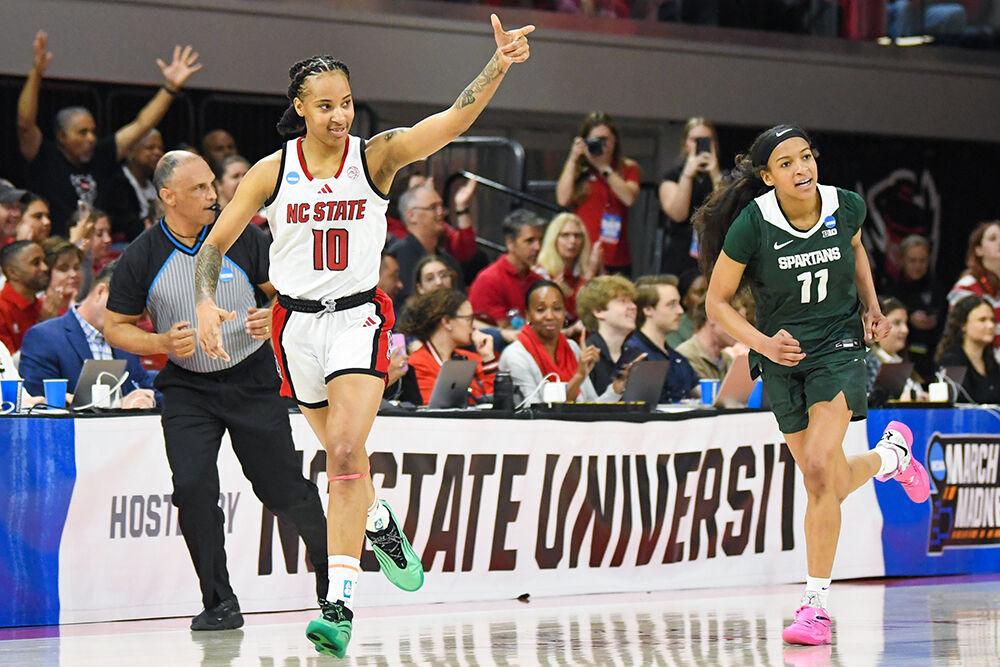 Senior guard Aziaha James points at senior guard Saniya Rivers after receiving a pass from her and scoring during the second round game of the NCAA Tournament against Michigan State in Reynolds Coliseum on Monday, March 24, 2025. James led the team in points, scoring 26, and also made two blocks and six assists. NC State won the game 83-49.