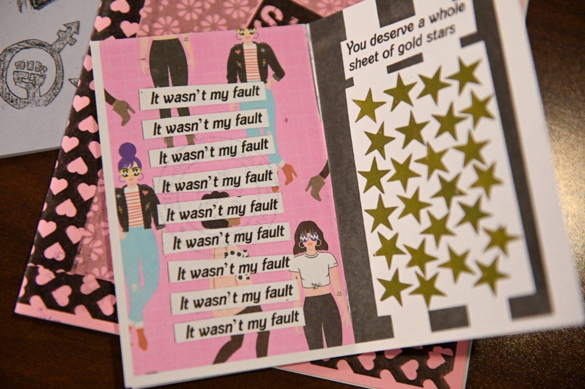 A zine entailing affirmations for sexual assault survivors from the Women's Center's zine library is posed during A Womanist History of Scrapbooks and Zines event in the Women's Center on Tuesday, March 25, 2025. The Women's Center's hosted the event to examine the role of scrapbooks and zines in feminist and womanist movements.