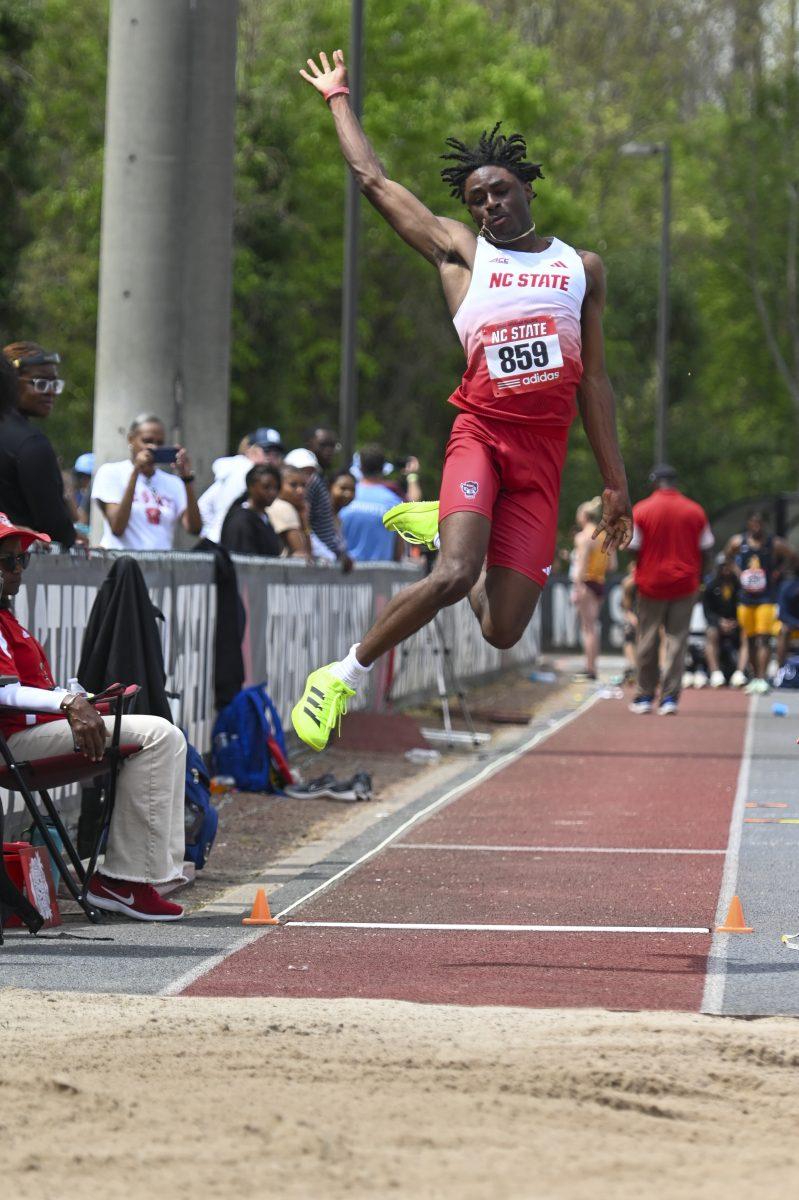 Freshman jumper Ryan Farness jumps into the sand pit during the Raleigh Relays track meet at the Derr Track and Field Facility on Saturday, March 29, 2025. In the long jump event Farness scaled 6.19m.