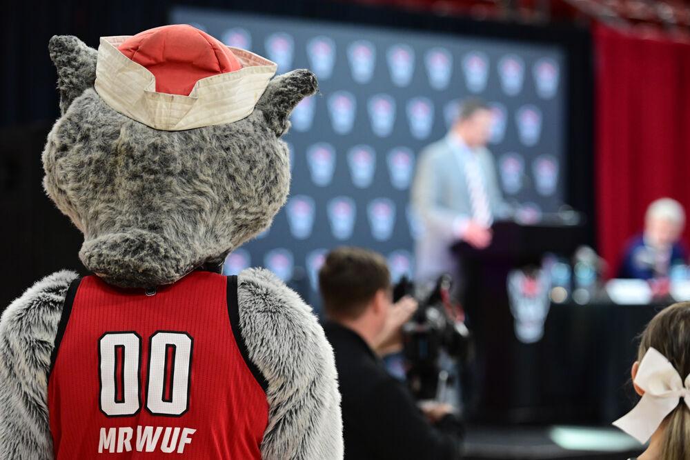 Mr. Wuf stands in the crowd as Will Wade, the new men's basketball coach, addresses the audience at his press conference inside Reynolds Coliseum on Tuesday, March 25, 2025. NC State introduced Will Wade as its 21st head coach in program history.