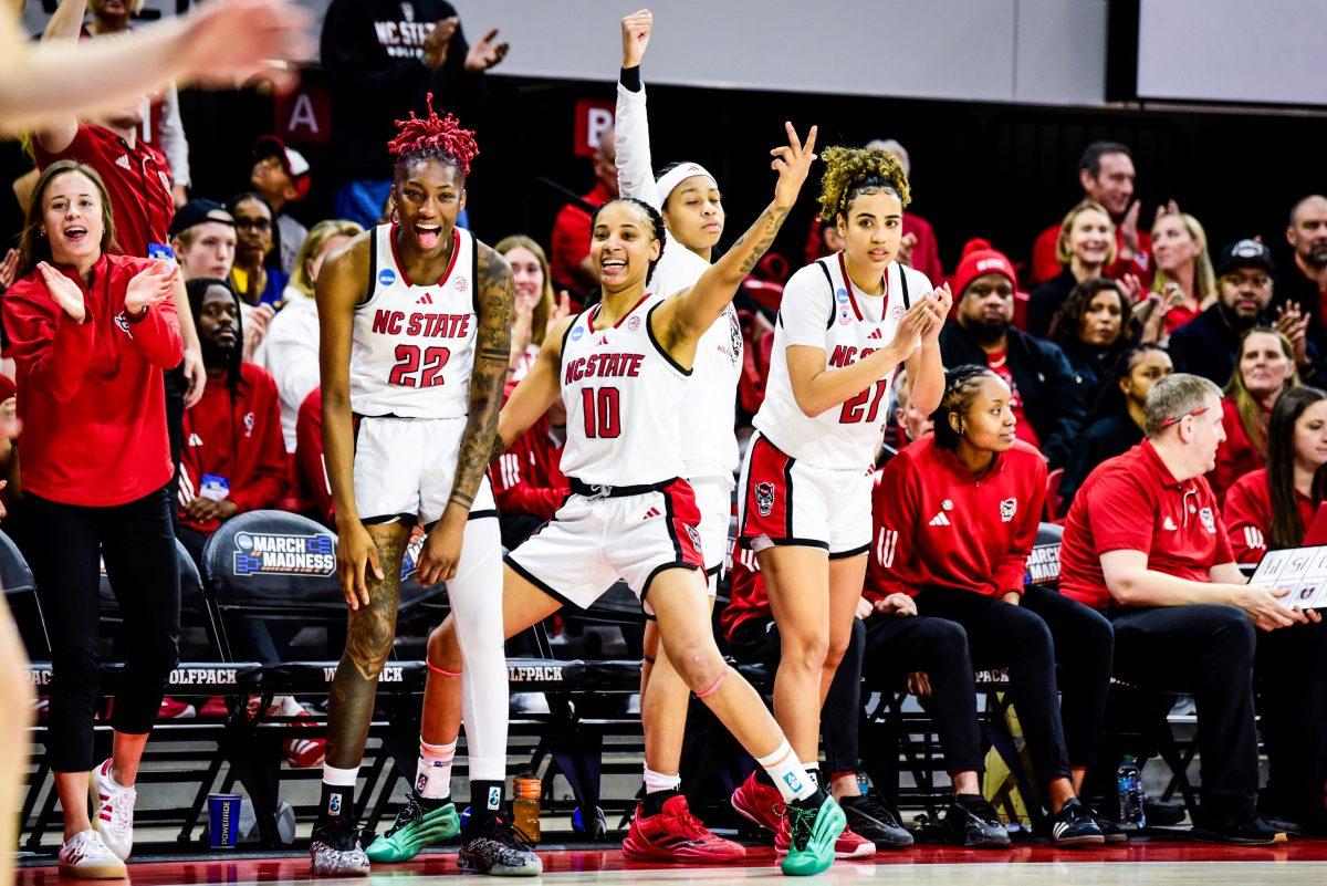 Senior guards Saniya Rivers, Aziaha James, and Madison Hayes celebrate a basket together during the game against Michigan State in Reynolds Colesium on Monday, March 24, 2025. The Wolfpack beat the Spartans 83-49.