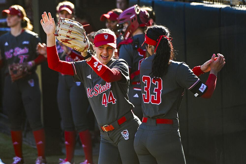 Senior infielder Taylor Ensley and senior infielder Alaina Smith bump hips before the game against UNC-Wilmington at Dail Softball Stadium on Friday, Feb. 28, 2025. Ensley had one hit. NC State lost to UNC-Wilmington 5-4.