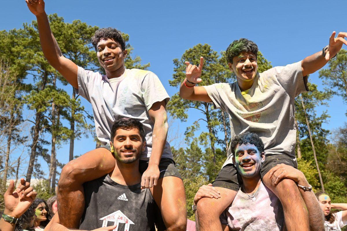 Students sit on the shoulders of their friends while dancing during Holi at Stafford Commons on Saturday, March 22, 2025. Holi was thrown by EKTAA, NC State's South Asian Student Association.