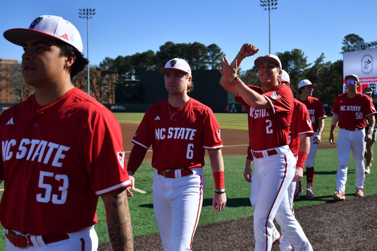NC State baseball players make their way back to the dugout before the game against the Canisius Golden Griffins on Doak Field at Dail Park on Friday, Feb. 28, 2025. The Wolfpack beat the Golden Griffins 10-2 to take the first game of the series.