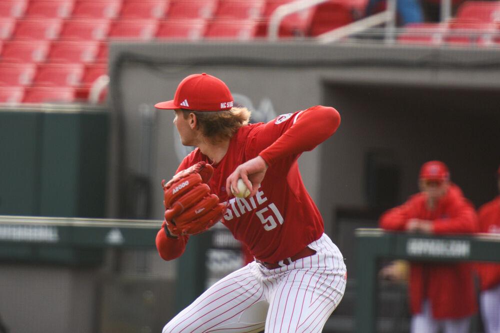 Junior pitcher Dominic Fritton recovers a loose ball for an out at first base during the game against Wright State on Doak Field at Dail Park on Friday, March 7, 2025. Fritton had ten strikeouts. The Wolfpack defeated the Raiders 6-4.