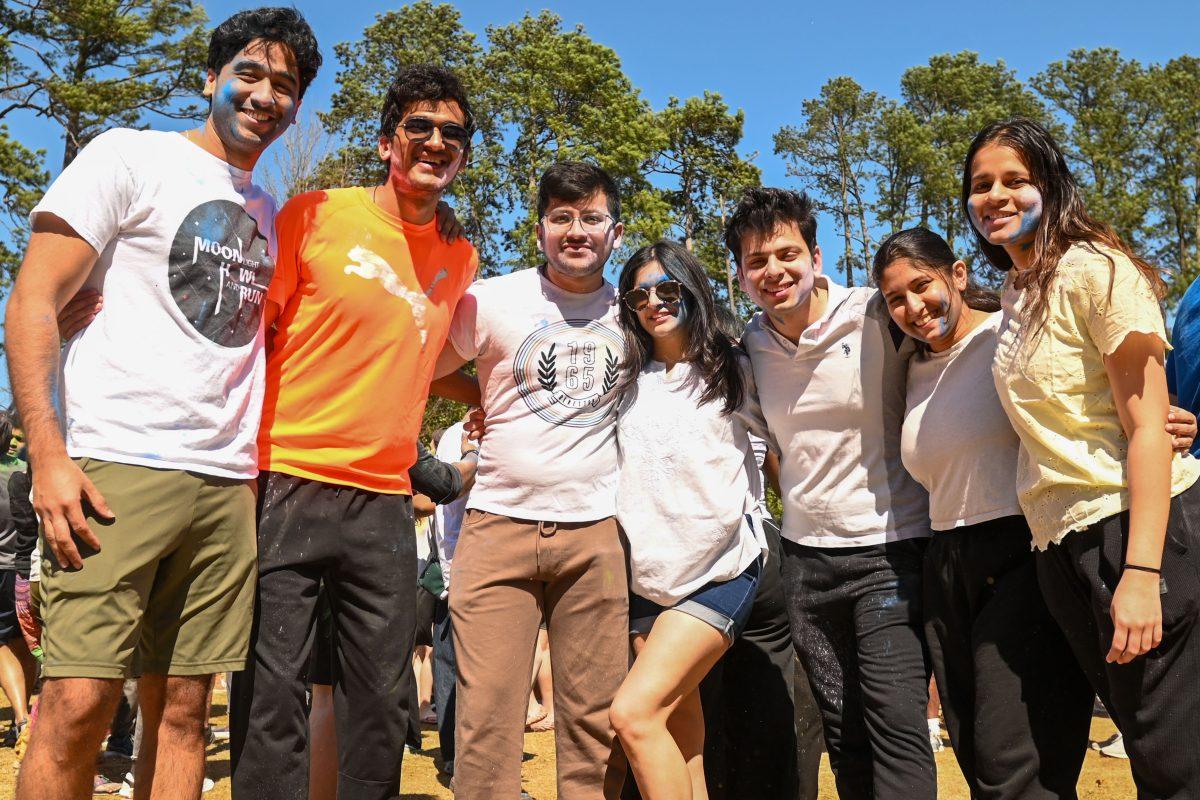 A group of friends pose together during Holi at Stafford Commons on Saturday, March 22, 2025. Holi is known as the Festival of Colors, and celebrates spring by throwing colored powder.