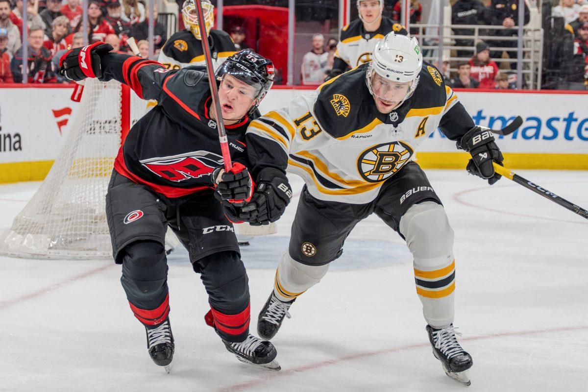 Forward Jackson Blake challenges the puck with a defender during the game against the Boston Bruins at the Lenovo Center on Saturday, March 6, 2025. Blake had one shot on goal. The Hurricanes beat the Bruins 3-2.