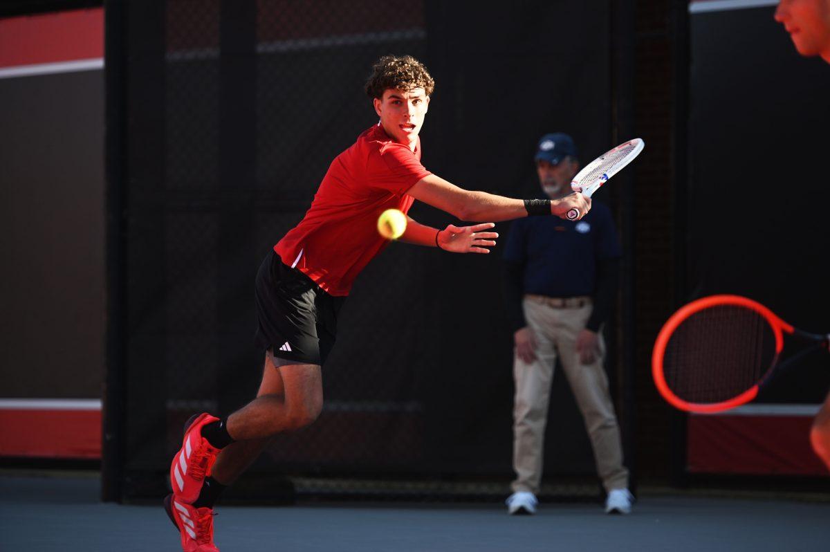 Redshirt freshman Jules Leroux lunges for the ball during his doubles match with senior Luca Staeheli during the match versus Cal at J.W. Isenhour tennis center on Friday, Feb. 28, 2025. Leroux and Staeheli's doubles match was unfinished. The Wolfpack beat the Golden Bears 4-2.