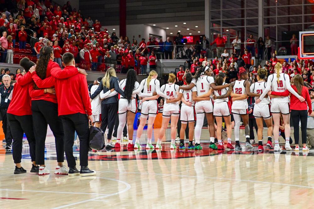 The women's basketball team and members of their staff sway along during the alma mater during the second round game of the NCAA Tournament against Michigan State in Reynolds Coliseum on Monday, March 24, 2025. The Wolfpack beat the Spartans 83-49.