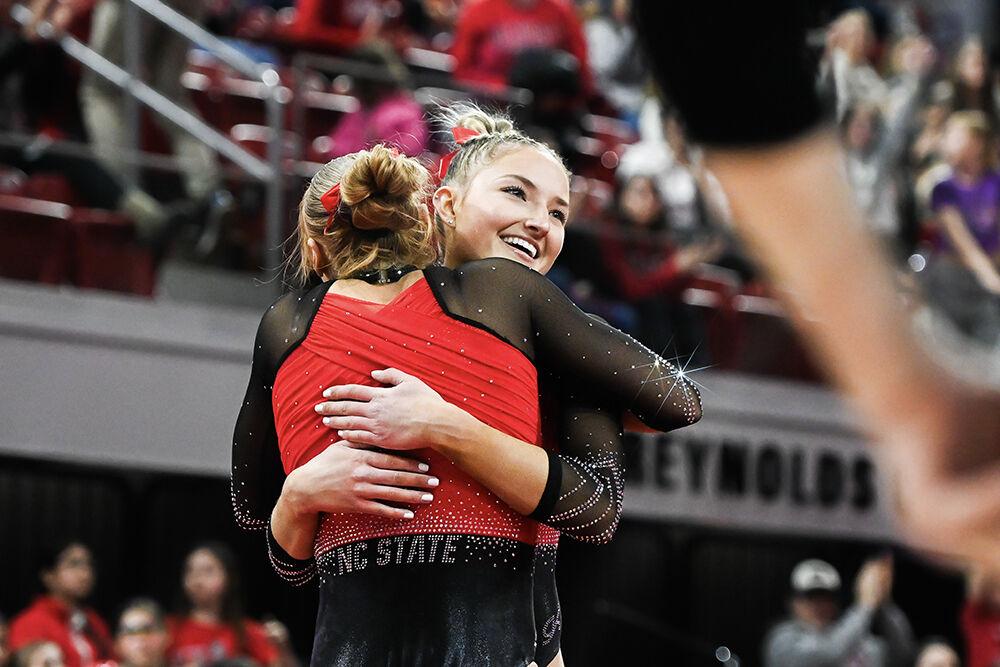 Graduate Krista Zultevicz and junior Kailee Adomaites embrace during the meet against Ohio State in Reynolds Coliseum on Friday, March 7, 2025. Zultevicz scored 9.775 in her floor routine and Adomaites scored 9.425 in her exhibition floor routine. NC State beat Ohio State 197.000-196.325.