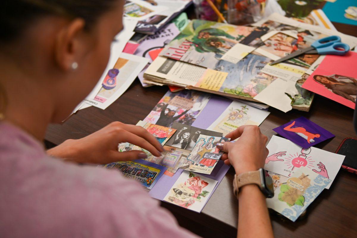 Shayla Bergeron, a second-year studying psychology, creates a zine in the Women's Center on Tuesday, March 25, 2025.&#160;The Women's Center's hosted the event to examine the role of scrapbooks and zines in feminist and womanist movements.