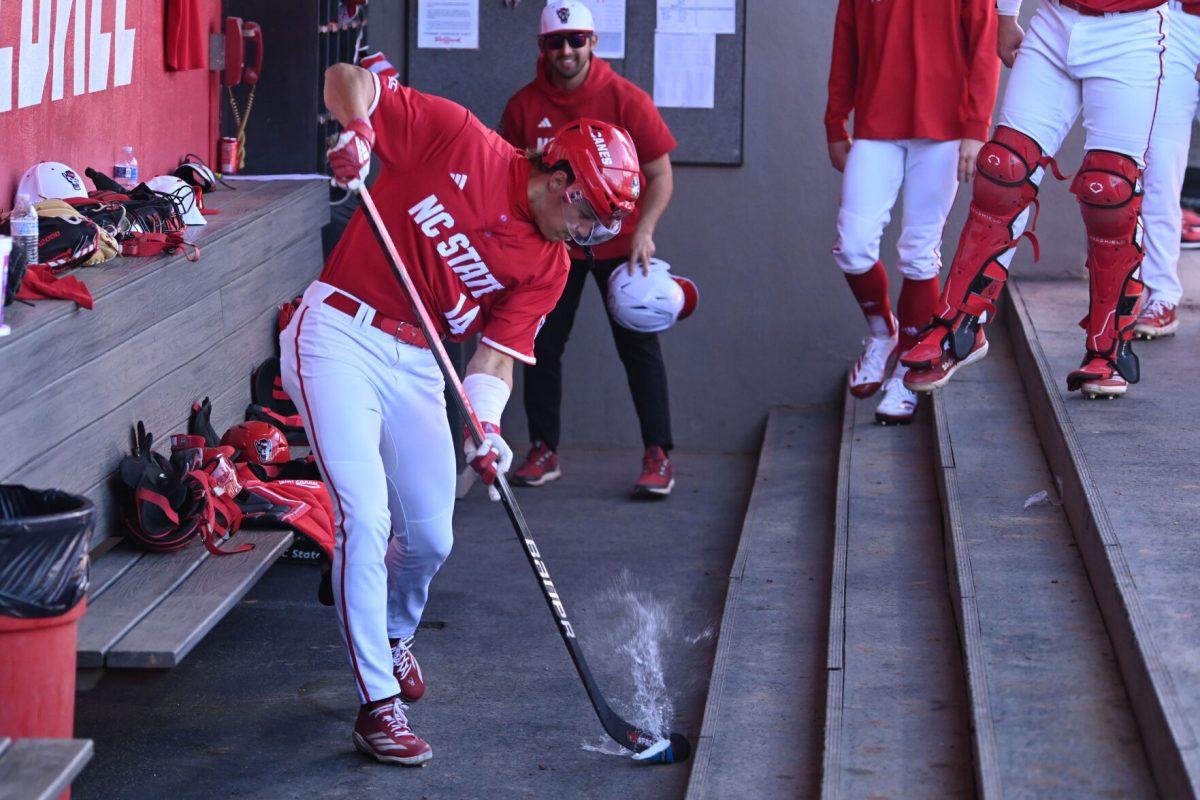 Freshman outfielder Ty Head preforms a hockey slapshot on a water cup as celebration for his grand slam home run during NC State's game against the Canisius Golden Griffins on Doak Field at Dail Park on Friday, Feb. 28, 2025. Head recorded five RBI's between the grand slam and a fly out. The Wolfpack beat the Golden Griffins 10-2 to take the first game of the series.