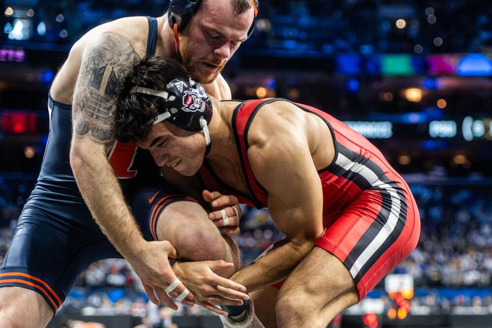 Redshirt sophomore Matty Singleton grabs his opponent's leg during the NCAA Wrestling Championship Tournament in the Wells Fargo Center on Friday, March 21, 2025. Singleton placed seventh in the 174 pound weight class. NC State placed eighth in the tournament with 46.5 points.