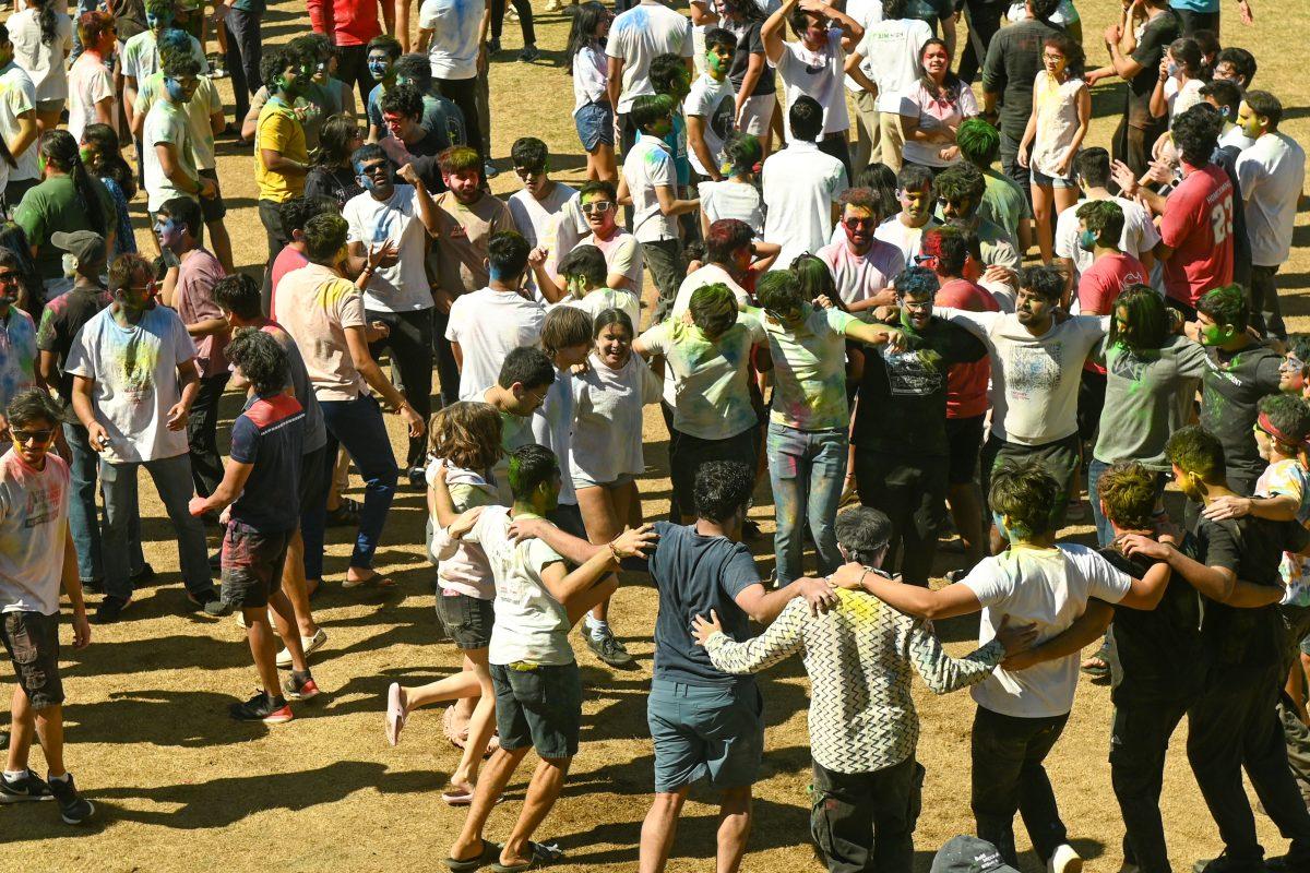 Students join arms in a dance circle during Holi at Stafford Commons on Saturday, March 22, 2025. Holi was thrown by EKTAA, NC State's South Asian Student Association.