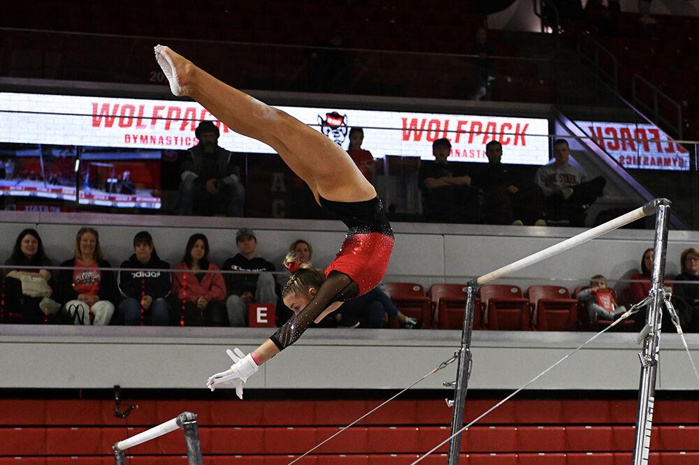 Junior Kailee Adomaites transitions between the uneven bars during the meet against Ohio State in Reynolds Coliseum on Friday, March 7, 2025. Adomaites scored 9.750 on the uneven bars. NC State beat Ohio State 197.000-196.325.