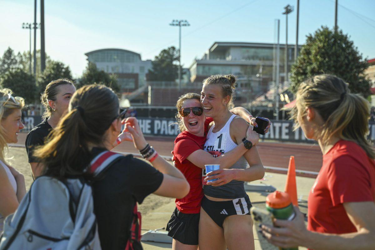 Members of the NC State Track and Field celebrates sophomore distance runner Angelina Napoleon after she won the 3000m steeplechase during the Raleigh Relays track meet at the Derr Track and Field Facility on Friday, March 28, 2025. Napoleon finished first with a time of 9:34.22, breaking the meet, facility and program record in the process. Napoleon currently holds the fastest 3000m steeplechase time in the NCAA.