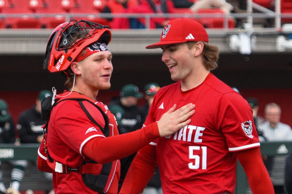 Sophomore catcher Alex Sosa and junior pitcher Dominic Fritton celebrate after a strikeout during the game against Wright State on Doak Field at Dail Park on Friday, March 7, 2025. The Wolfpack defeated the Raiders 6-4.