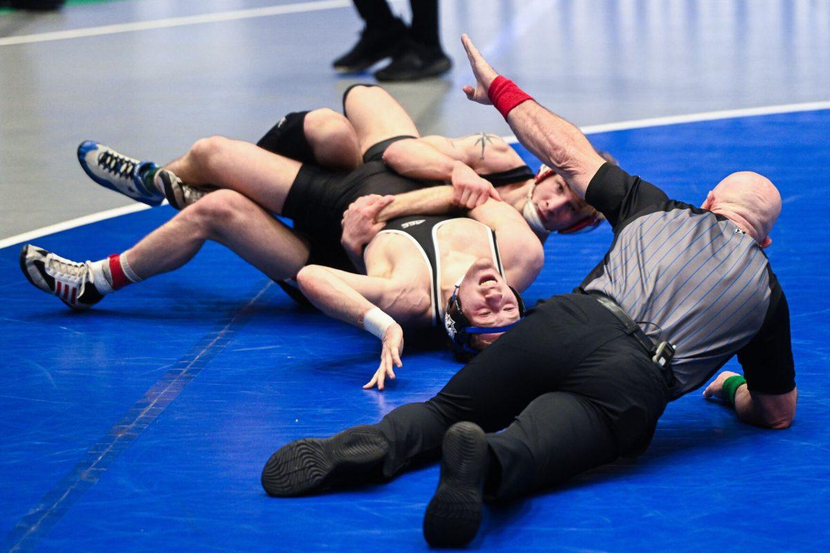 Senior Ed Scott holds his opponent to the mat during the ACC Wrestling Championship Tournament in Cameron Indoor Stadium on Sunday, March 9, 2025. Scott placed second in the 157 weight class. The Wolfpack placed third in the tournament with 62.5 points.