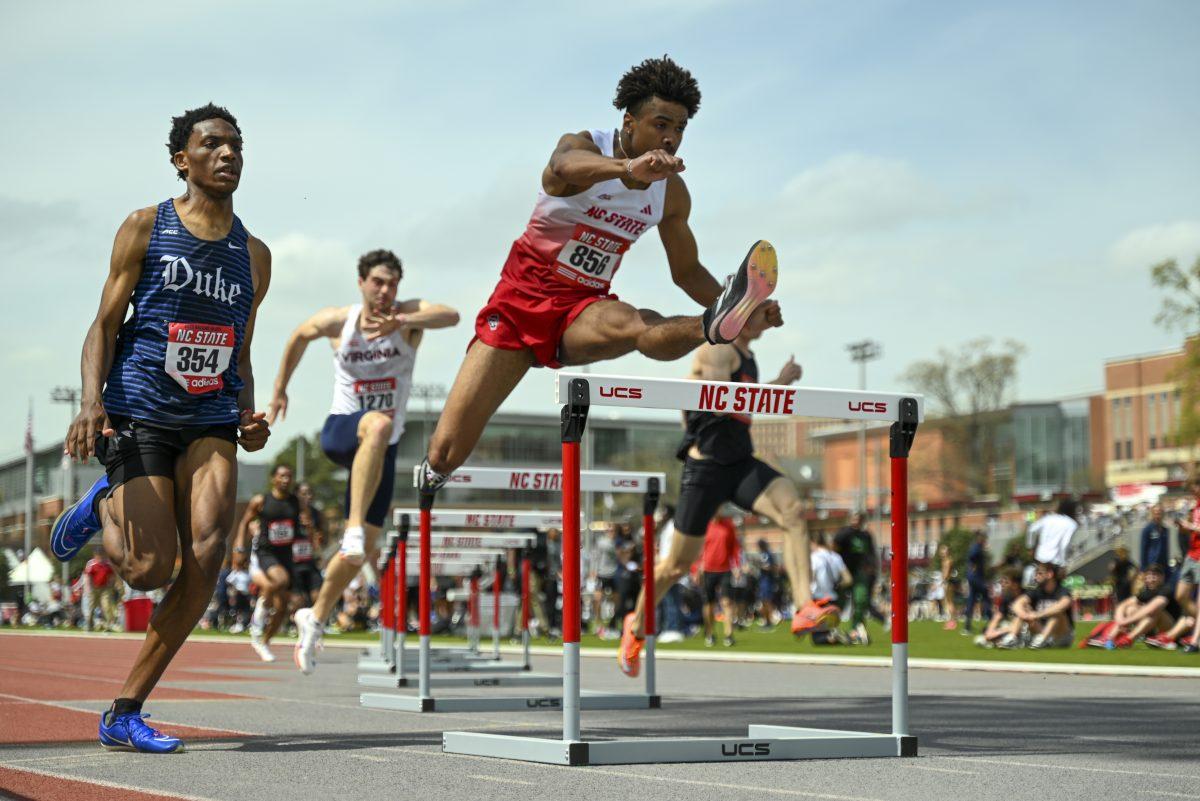 Sophomore hurdler Xavier Branker leaps over the hurdle during the Raleigh Relays track meet at the Derr Track and Field Facility on Saturday, March 29, 2025. Branker finished third in the 400m hurdle with a time of 51.21.