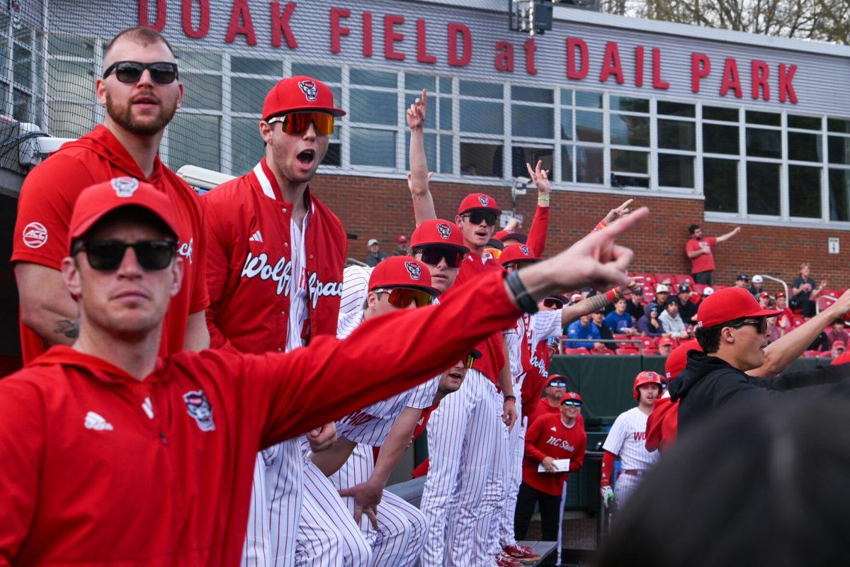 NC State dugout erupts in celebration as the ball sails out of the park during the game against Campbell on Doak Field at Dail Park on Wednesday, March 5, 2025. The Wolfpack defeated the Fighting Camels 11-1.