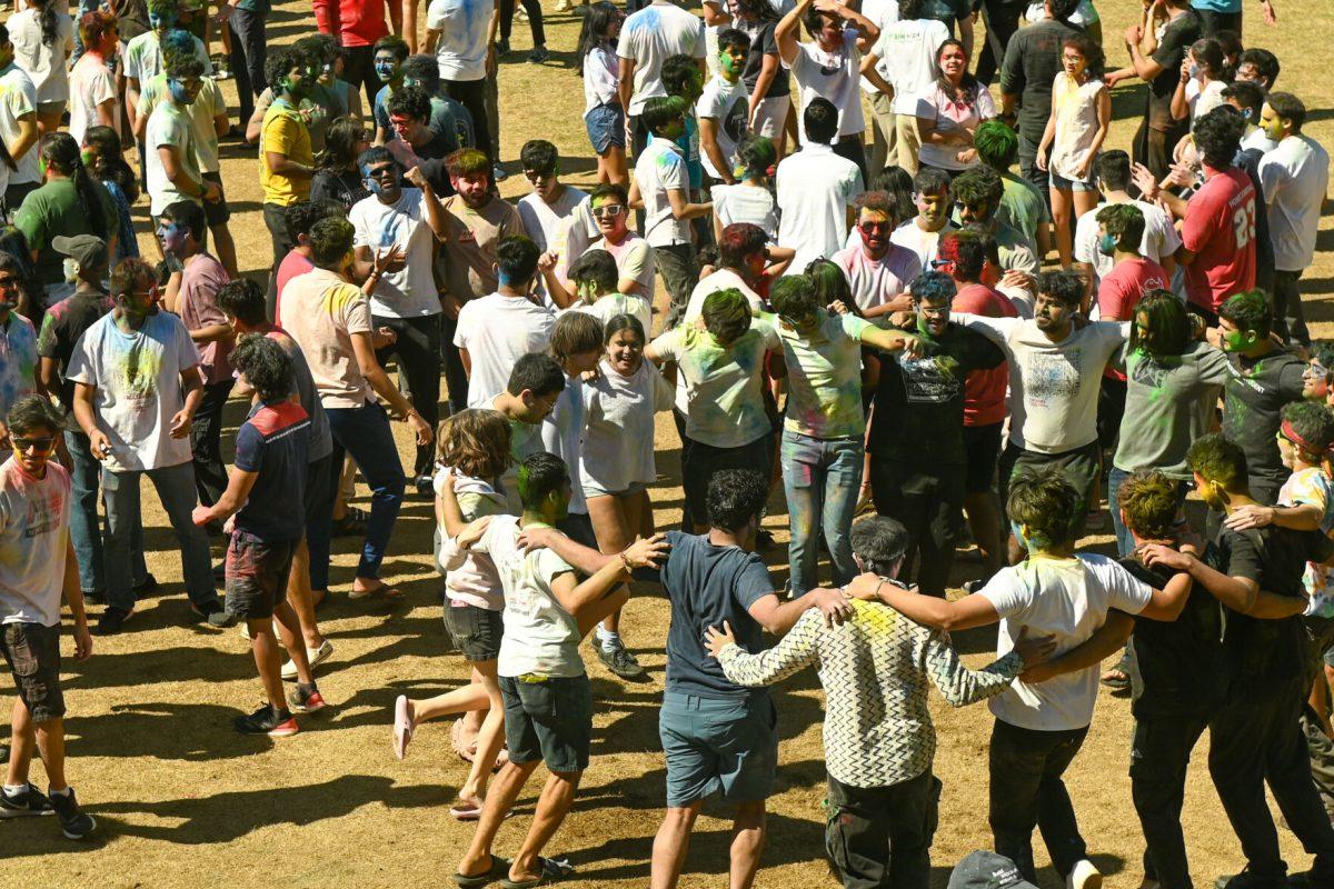 Students join arms in a dance circle during Holi at Stafford Commons on Saturday, March 22, 2025. Holi was thrown by EKTAA, NC State's South Asian Student Association.