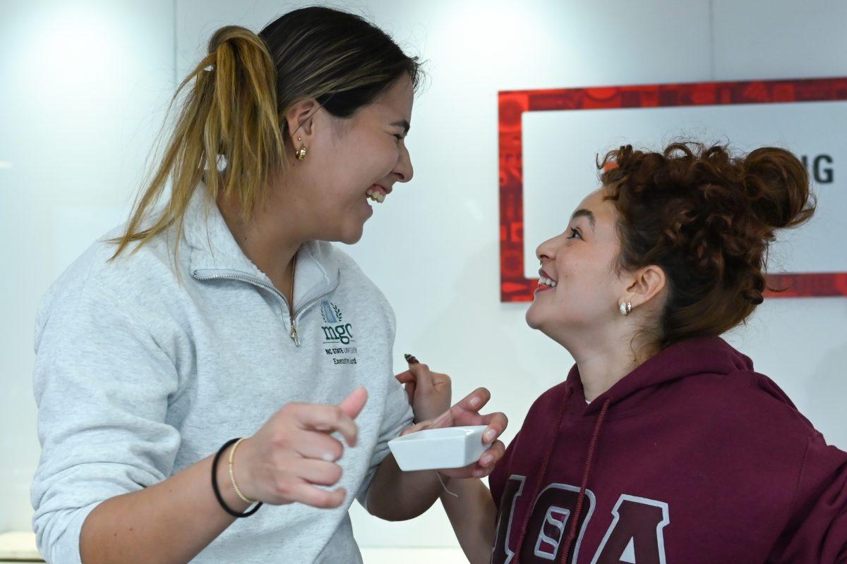 Silvana Ostolaza Pastor, a third-year studying criminology and political science, and Valeria Gonzalez Perez, a fourth-year studying zoology, crack jokes as members on opposing teams during the MGC Chopped: Cooking Competiton at Carmichael Gym on Wednesday, March 26, 2025. The event was organized by members of the Multicultural Greek Council.