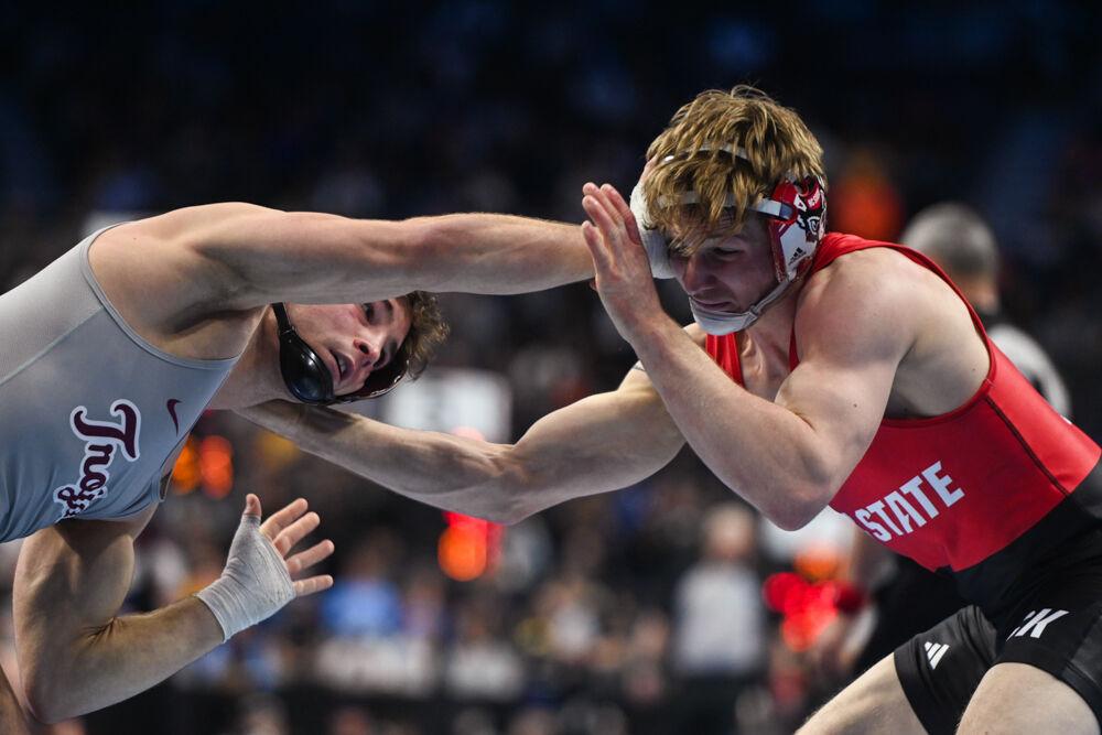 Senior Ed Scott pushes his opponent's wrist during the first round of the NCAA Wrestling Championship Tournament in Wells Fargo Center on Thursday, March 20, 2025.