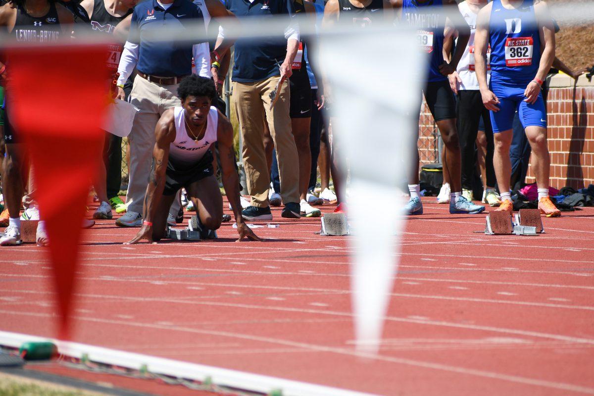 Freshman sprinter Brandon Harris gets set for the 100m during the Raleigh Relays track meet at the Derr Track and Field Facility on Friday, March 28, 2025. Harris finished second in his heat of the men's 100m with a time of 10.86.