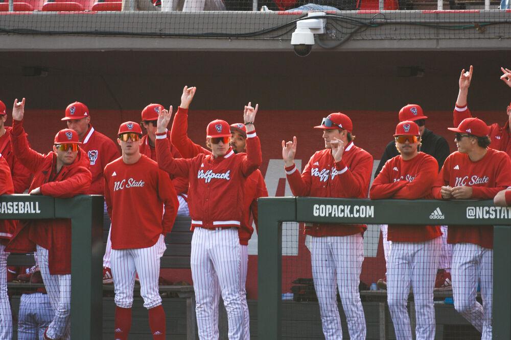 NC State's dugout throws up "wolfies" before their game against Wright State&#160;on Doak Field at Dail Park on Friday, March 7, 2025. The Wolfpack defeated the Raiders 6-4.