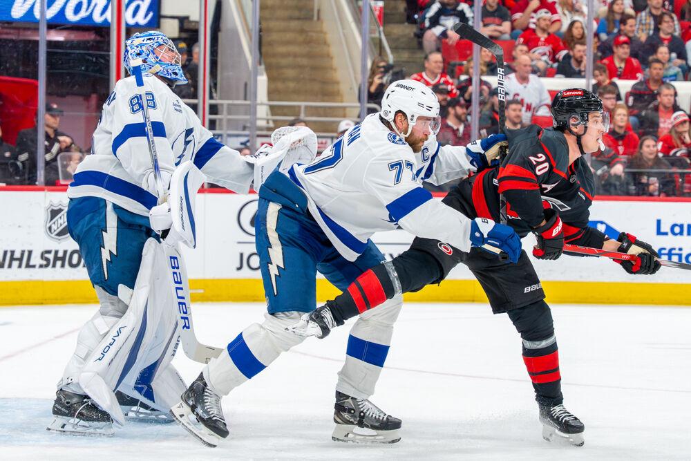 Center Sebastian Aho is pushed by an opposing defender during the game against the Tampa Bay Lightning at the Lenovo Center on Tuesday, March 11, 2025. Aho had two shots on goal. The Hurricanes beat the Lightning 4-1.