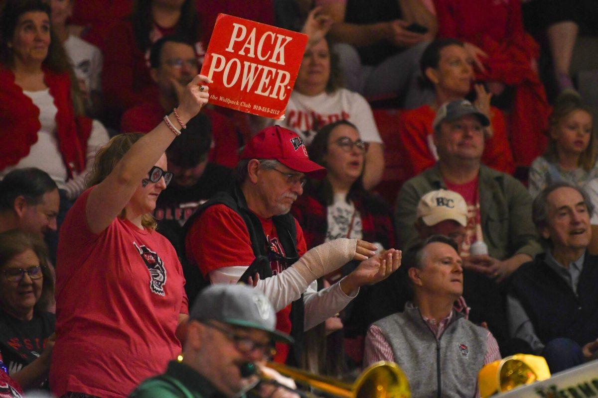 A fan holds up a sign reading "Pack Power" during the first round game of the NCAA Tournament against Vermont in Reynolds Coliseum on Saturday, March 22, 2025. NC State won the game 75-55.