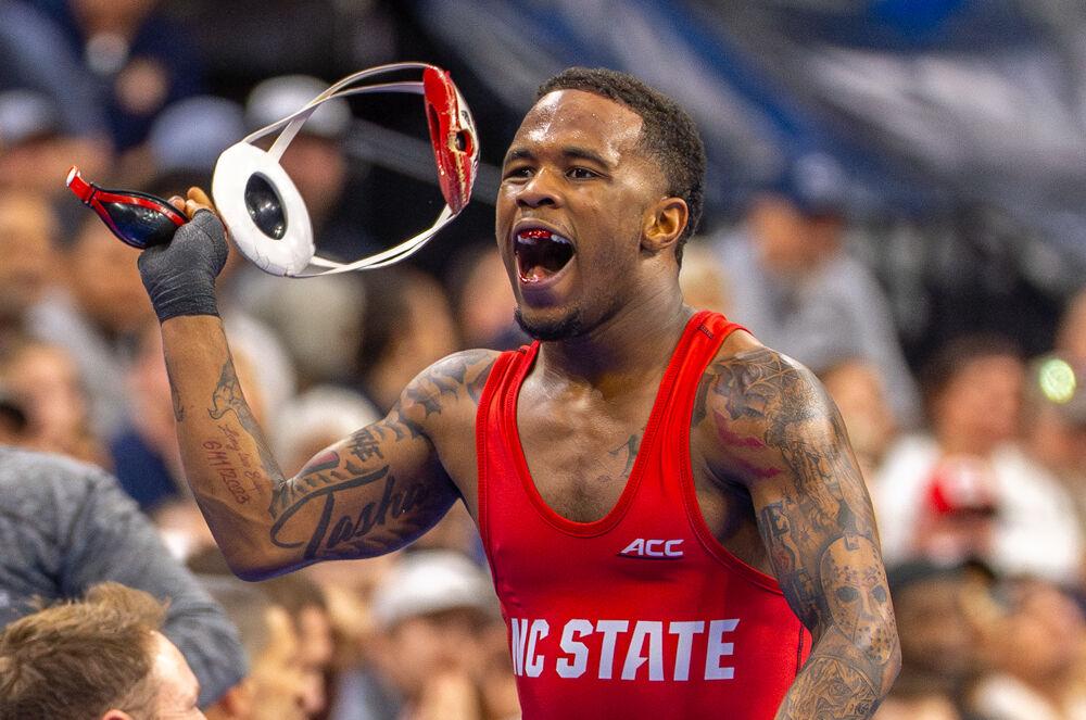 Redshirt freshman Vince Robinson celebrates his win during the NCAA Wrestling Championship Tournament in the Wells Fargo Center on Thursday, March 20, 2025.&#160;Robinson won the championship for the 125 pound weight class. NC State placed eighth overall with 46.5 points.