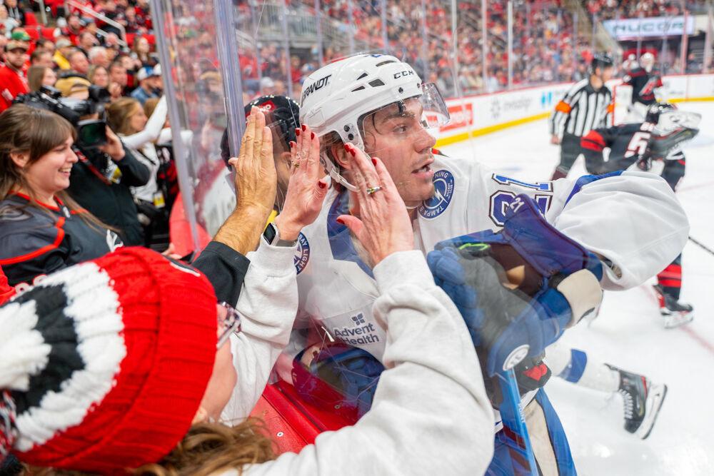Carolina Hurricanes fans slam their hands onto the glass during the game against the Tampa Bay Lightning at the Lenovo Center on Tuesday, March 11, 2025. The Hurricanes beat the Lightning 4-1.